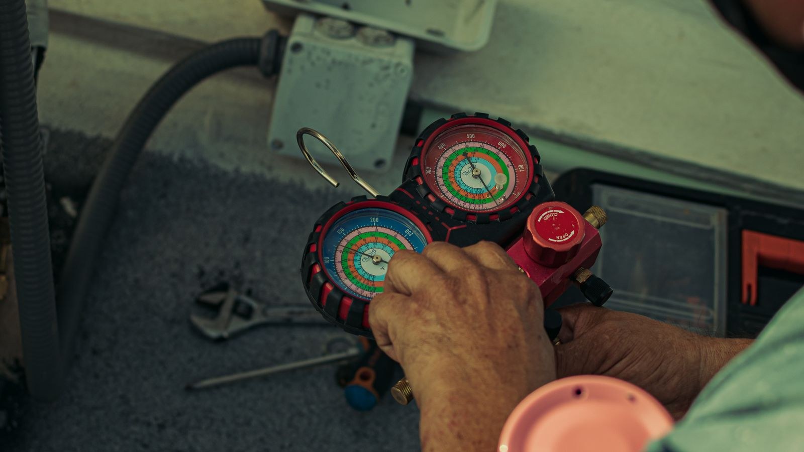 Close-up of a technician using tools to service air conditioner components