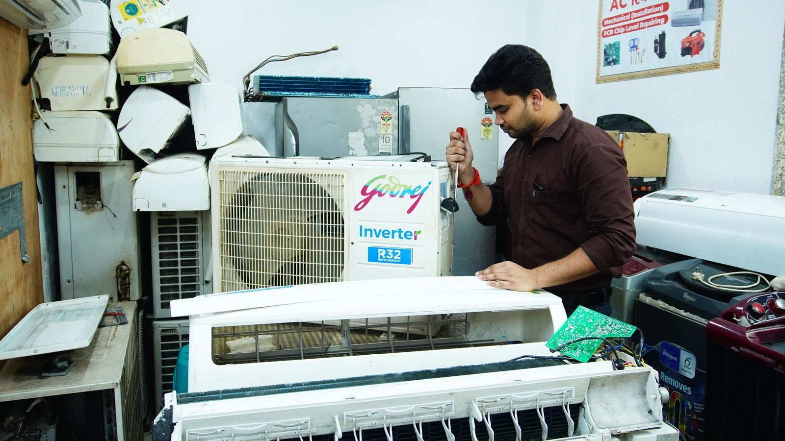 Air conditioner unit being repaired and cleaned on a workbench