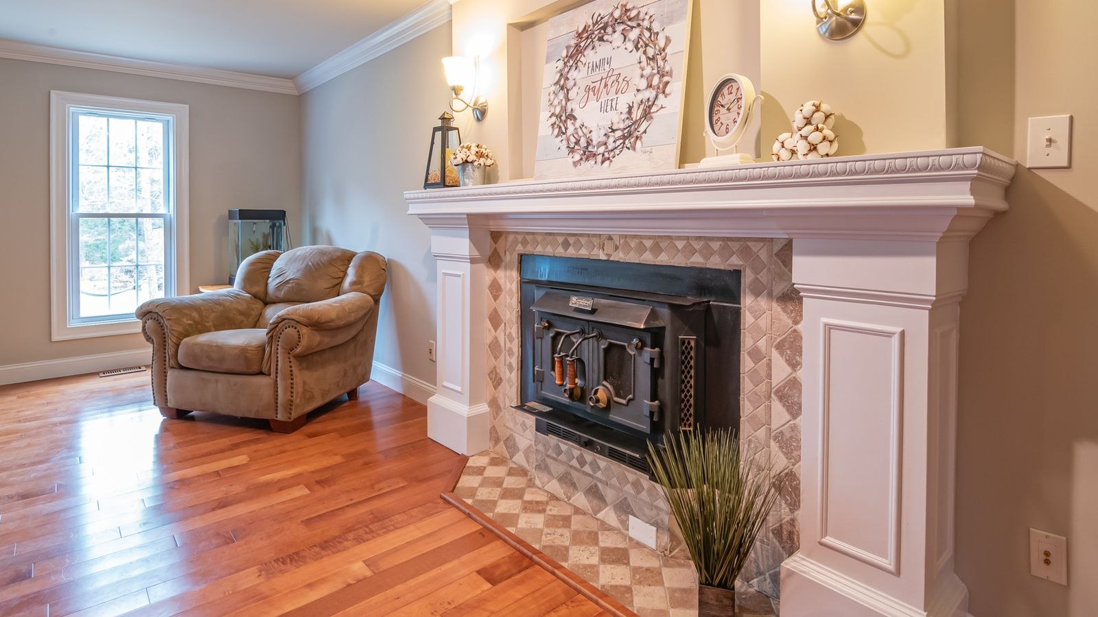Asymmetric mantel styling with candlesticks vases and a leaning mirror
