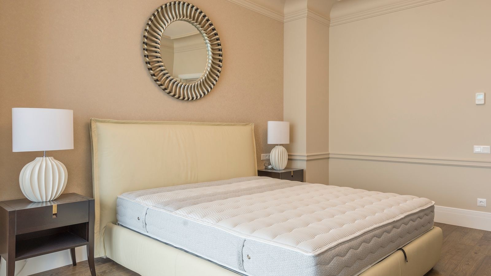 Vacuuming a mattress surface with an upholstery attachment
