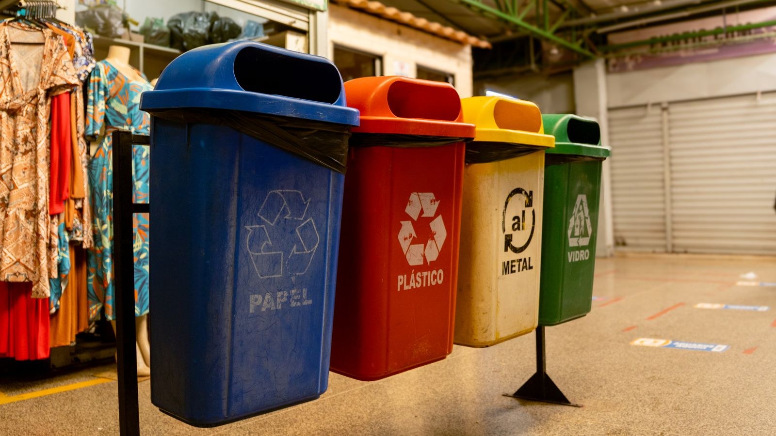 Colour coded recycling bins used for sorting glass and household waste