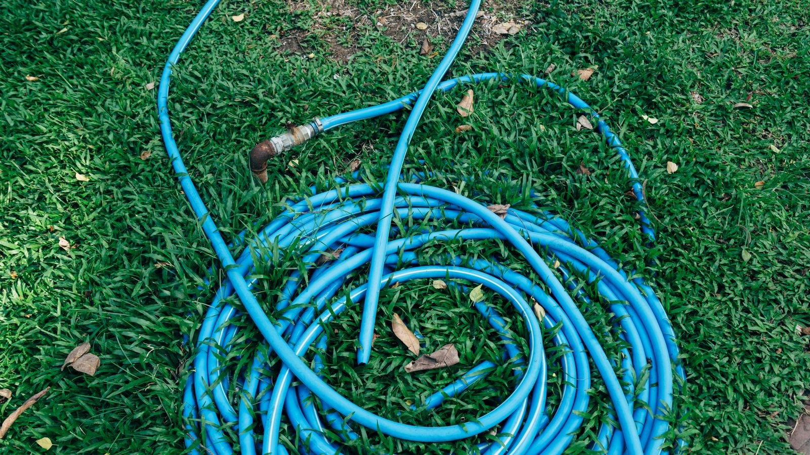 Coiled drain hose ready to be connected to a dehumidifier for continuous drainage