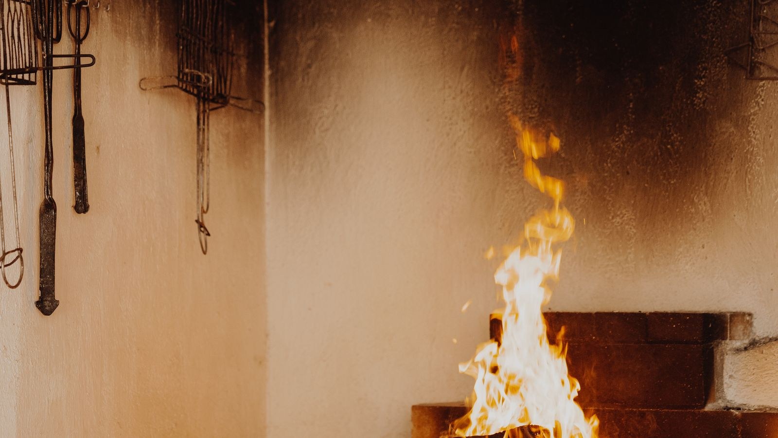 Wood burning fireplace with glowing logs, a common carbon monoxide source in homes