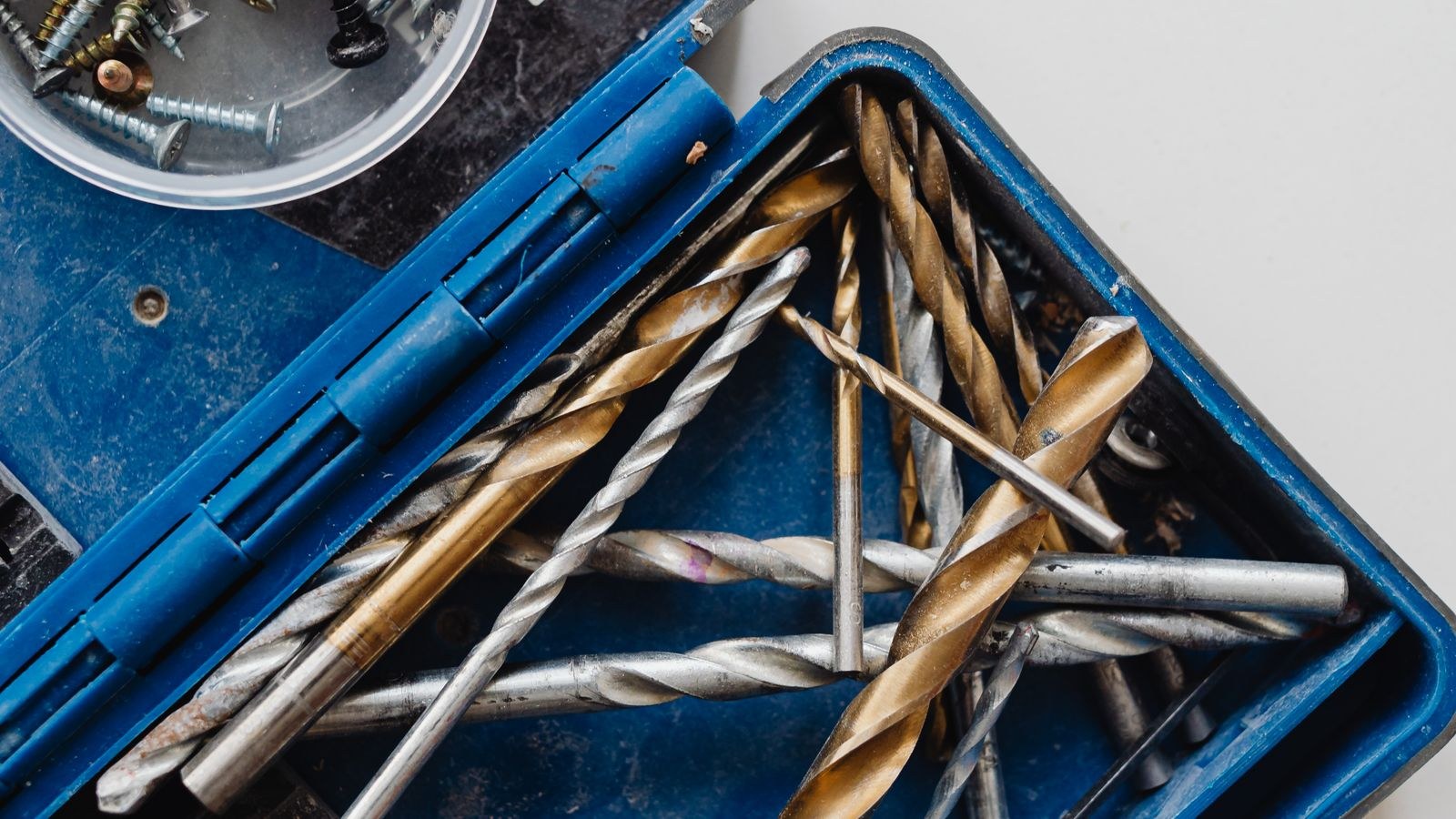 Toolkit with assorted drill bits and screws for furniture repairs