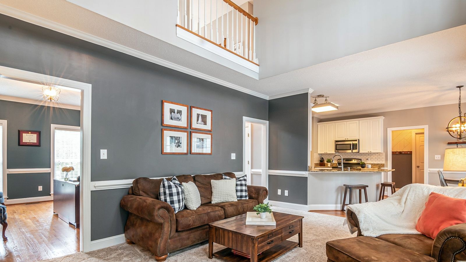 Open-plan living area with sofas floated to divide the space from the kitchen