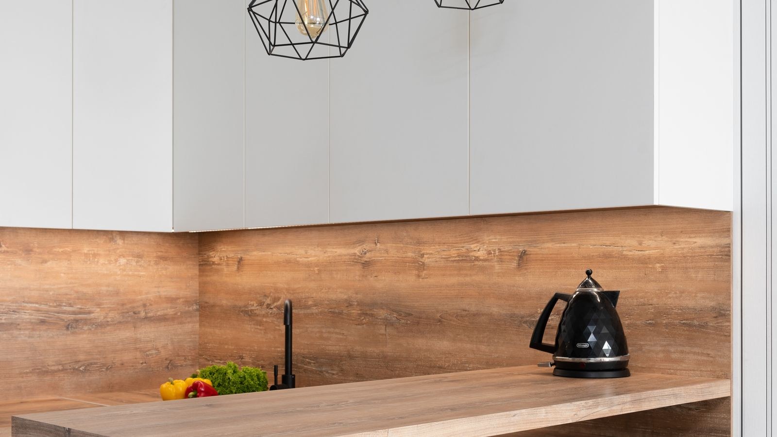 Warm pendant lighting illuminating a kitchen island work surface