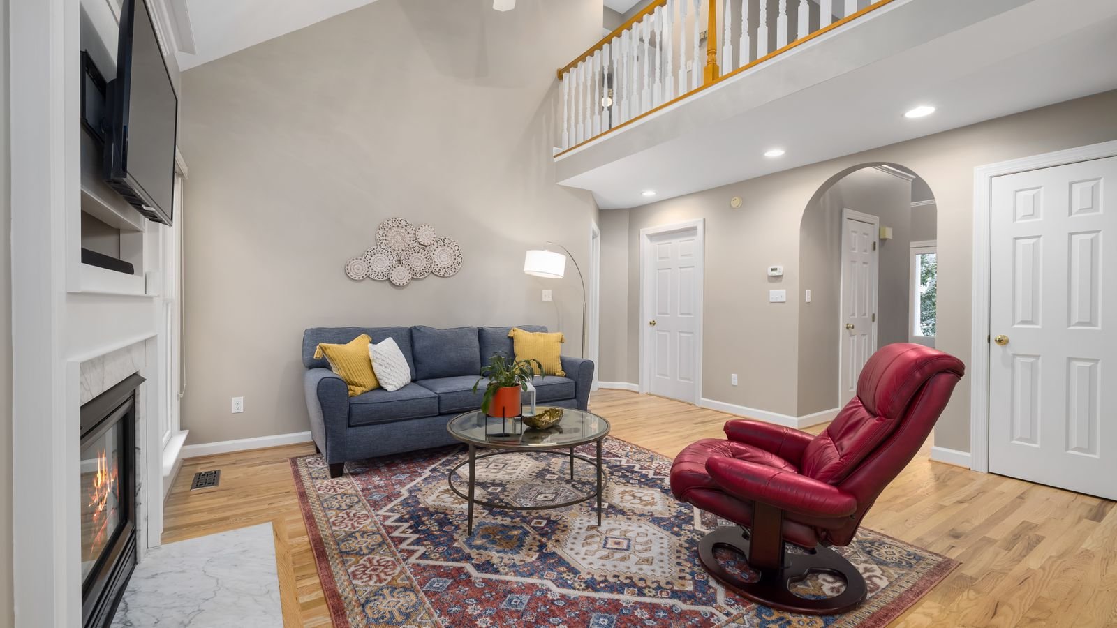 Ceiling fan installed on a high vaulted ceiling in a spacious living room