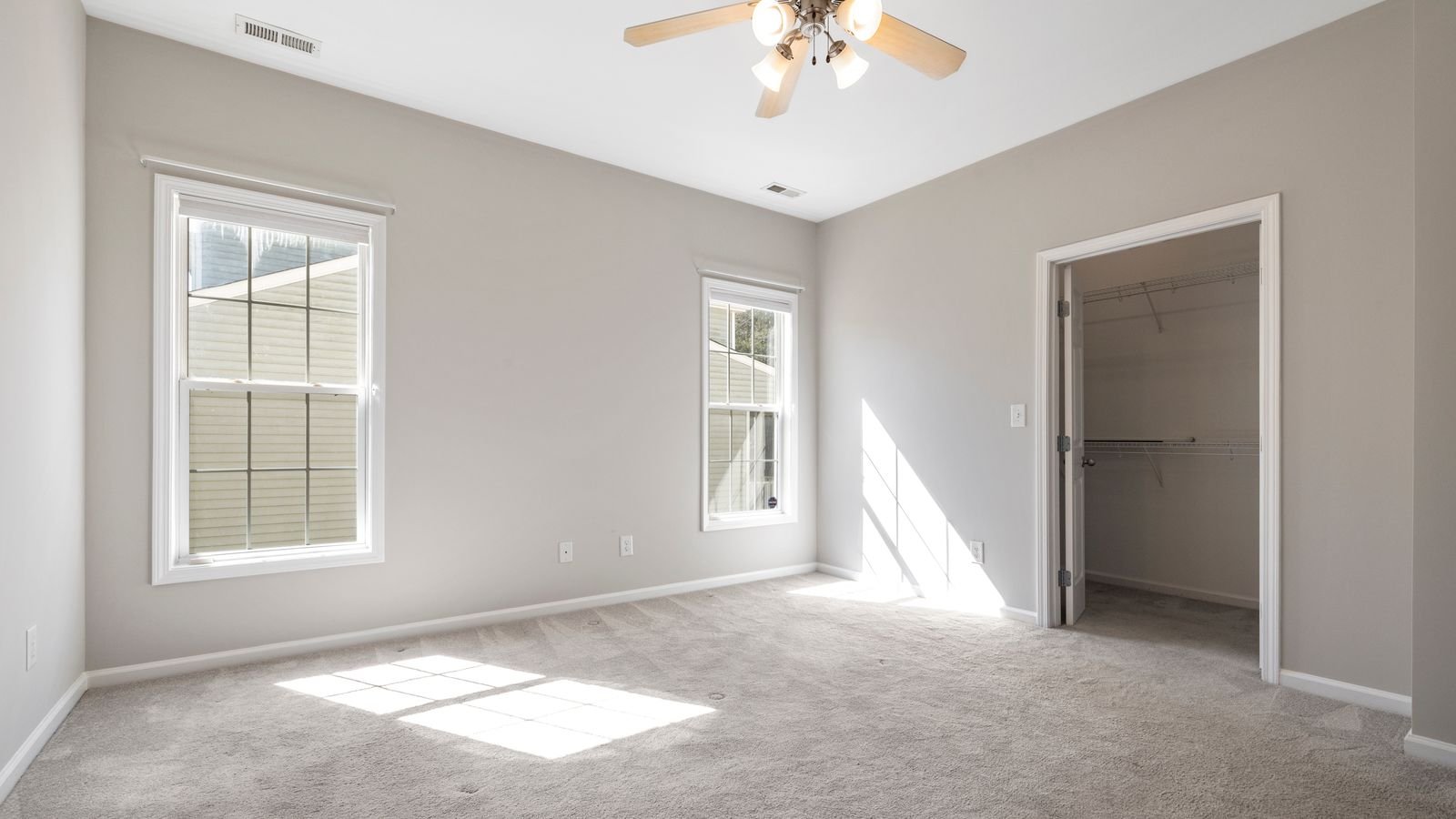 Close up of ceiling fan blades and light kit indoors