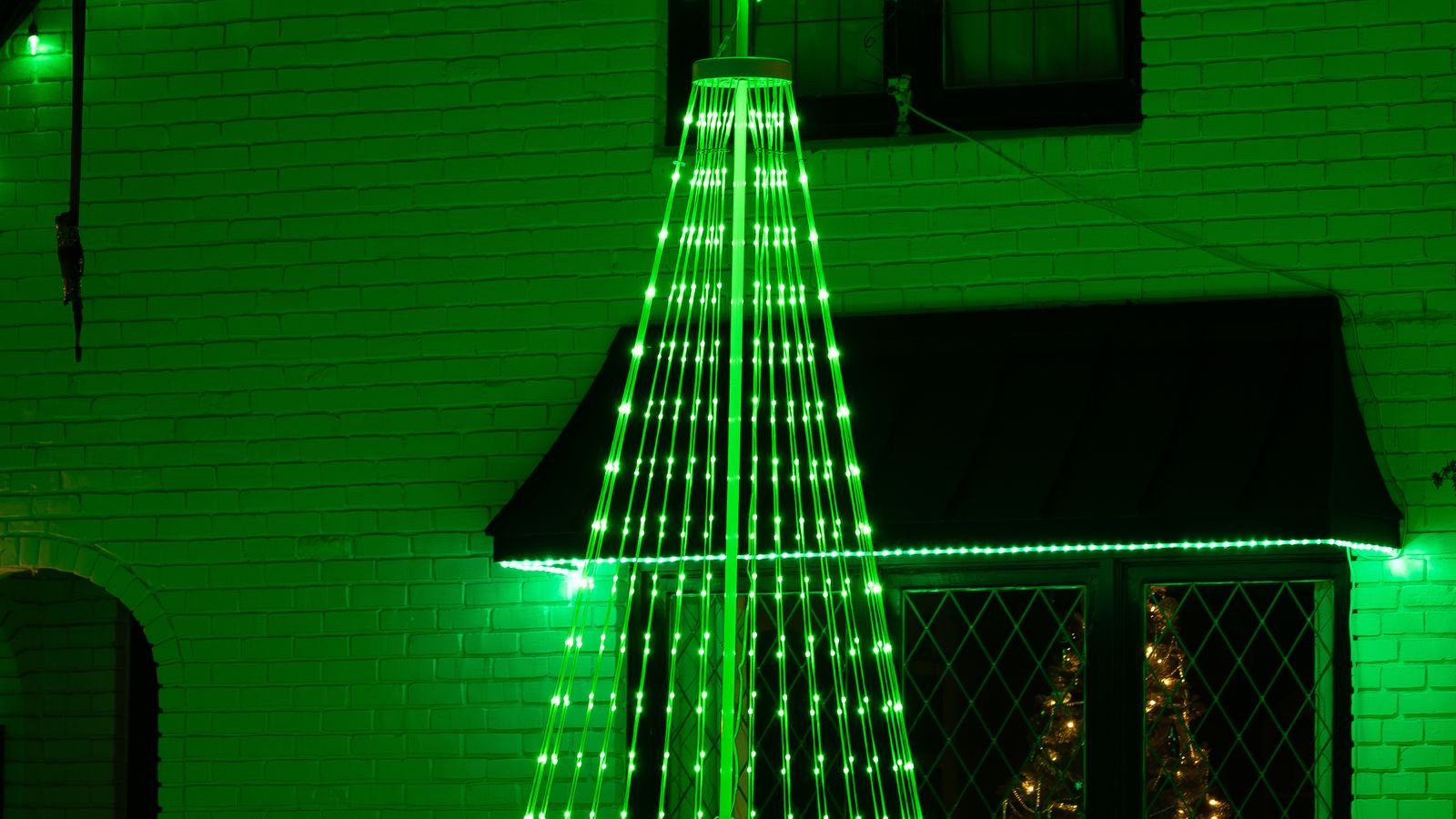 House exterior decorated with festive holiday lights on a timer schedule