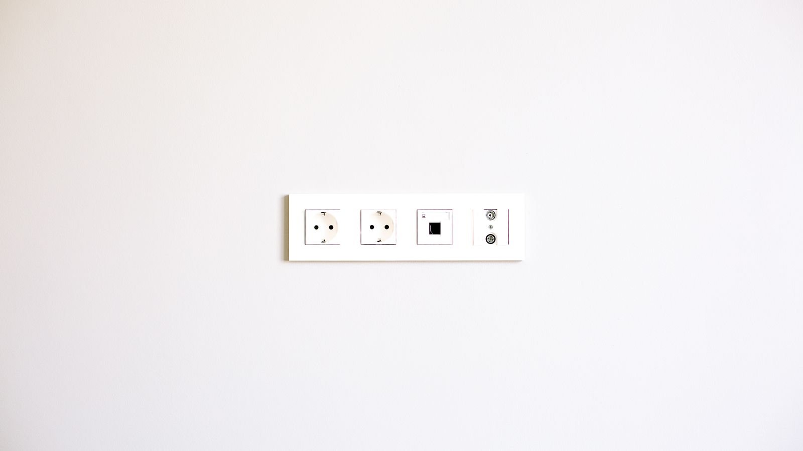 Close up of an electrical socket and wiring being installed in a wall box