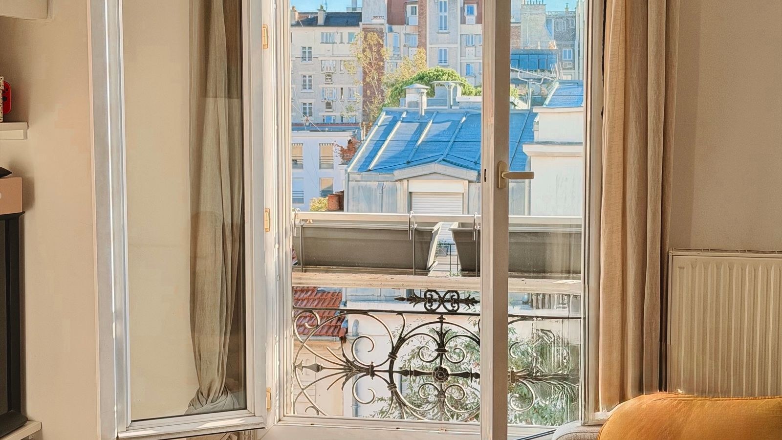 Bright apartment living room window used as a placement spot for a rental security camera