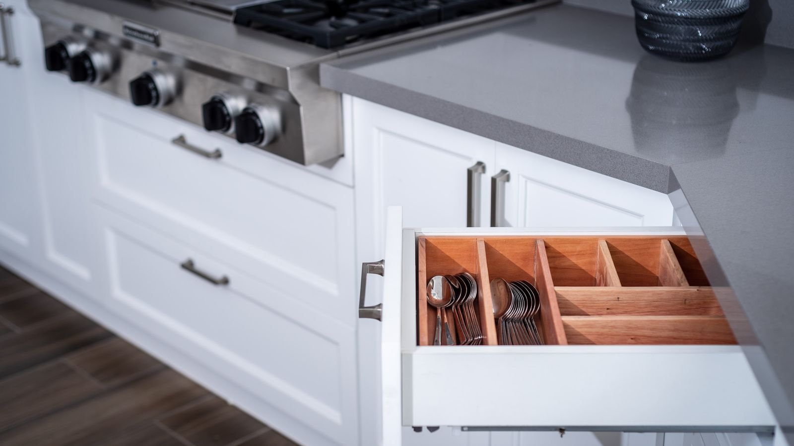 Close-up of a modern kitchen drawer and cabinetry under bright task lighting