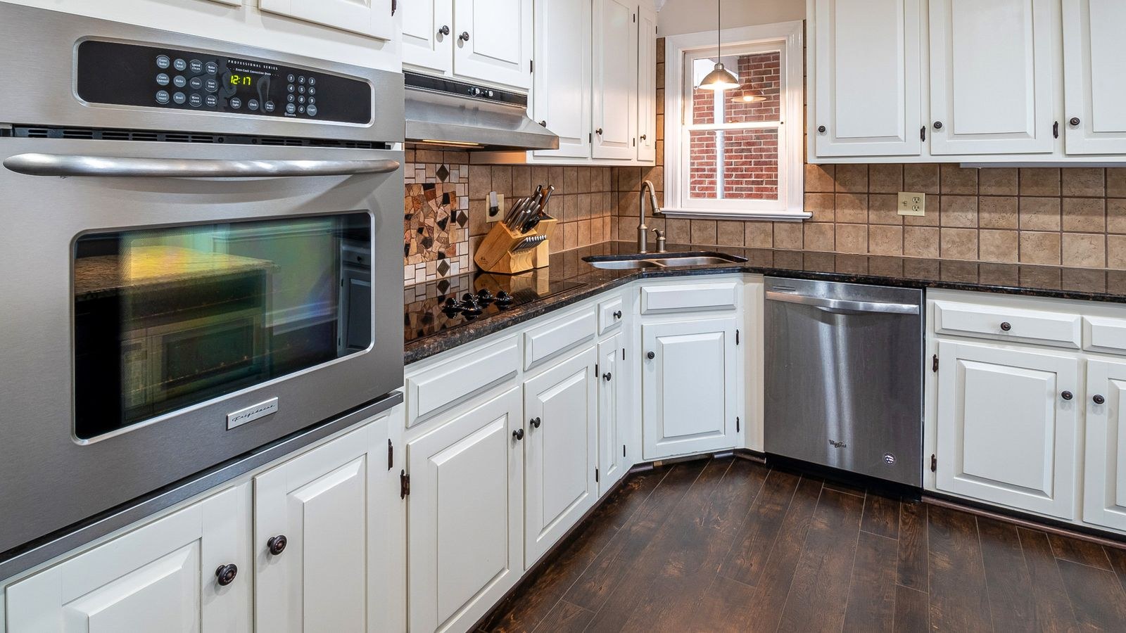 Kitchen cabinets with warm under cabinet lighting above the counter