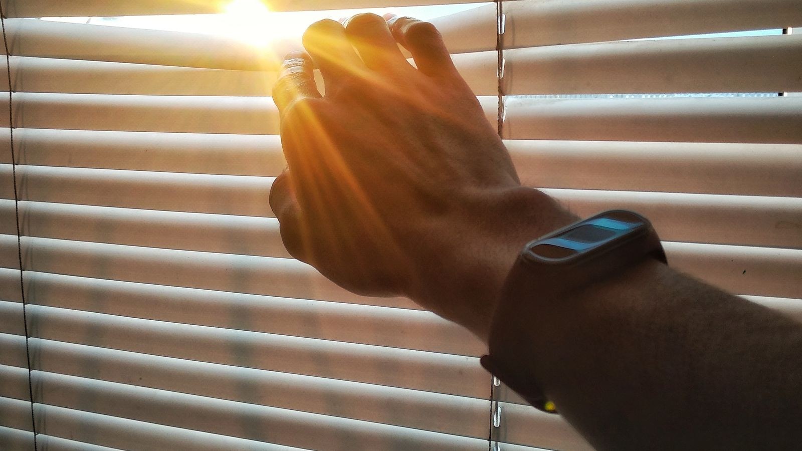 Installer measuring a window opening before mounting blinds