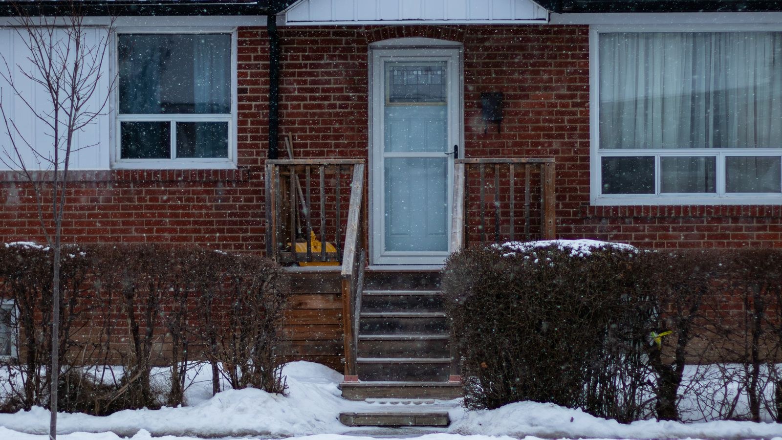 Snow covered suburban house entrance in deep winter