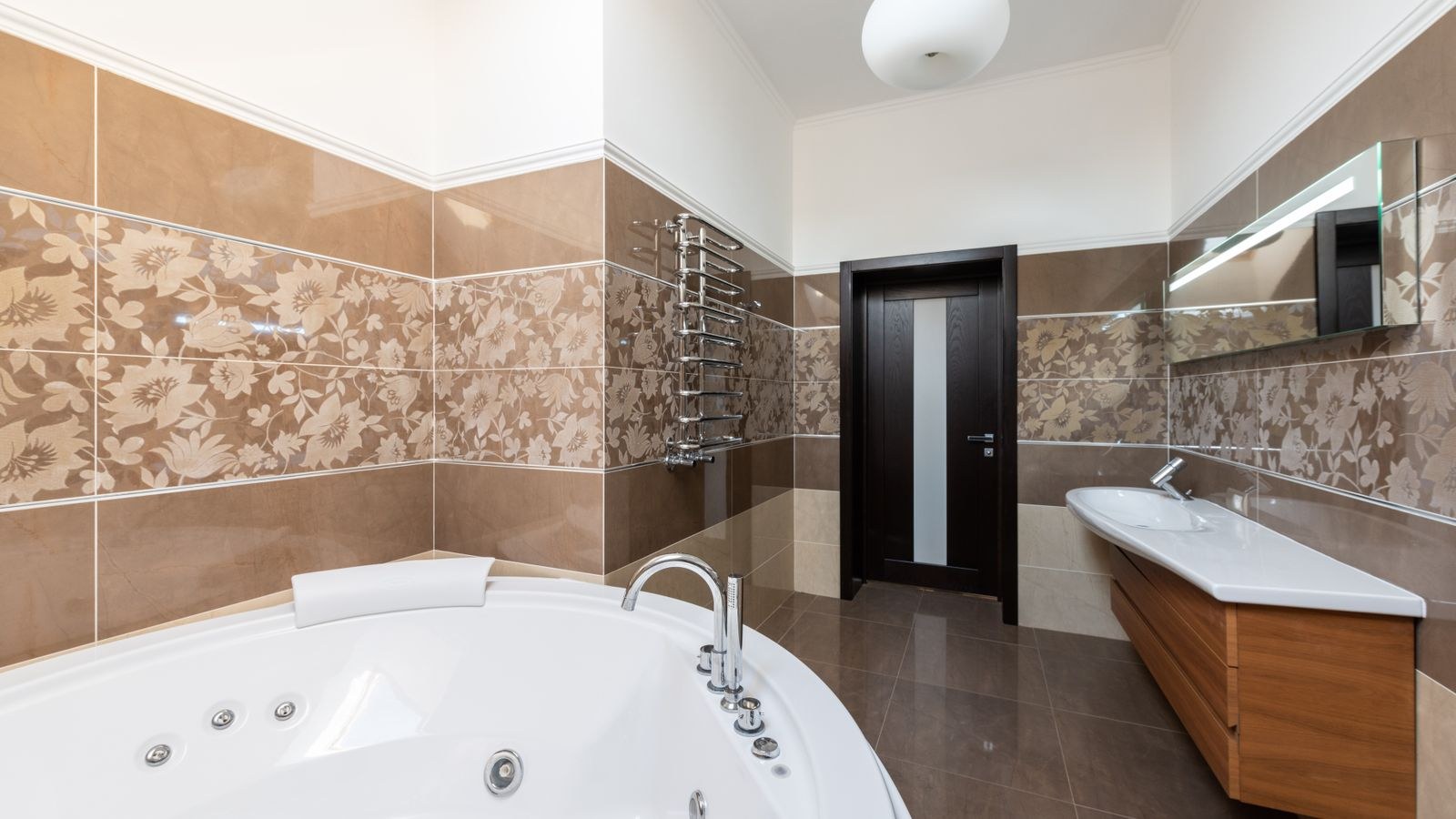 Bright modern bathroom interior with layered ceiling and vanity lighting