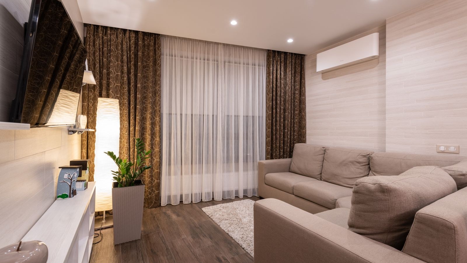 Stylish cozy living room with wooden flooring and soft layered lighting