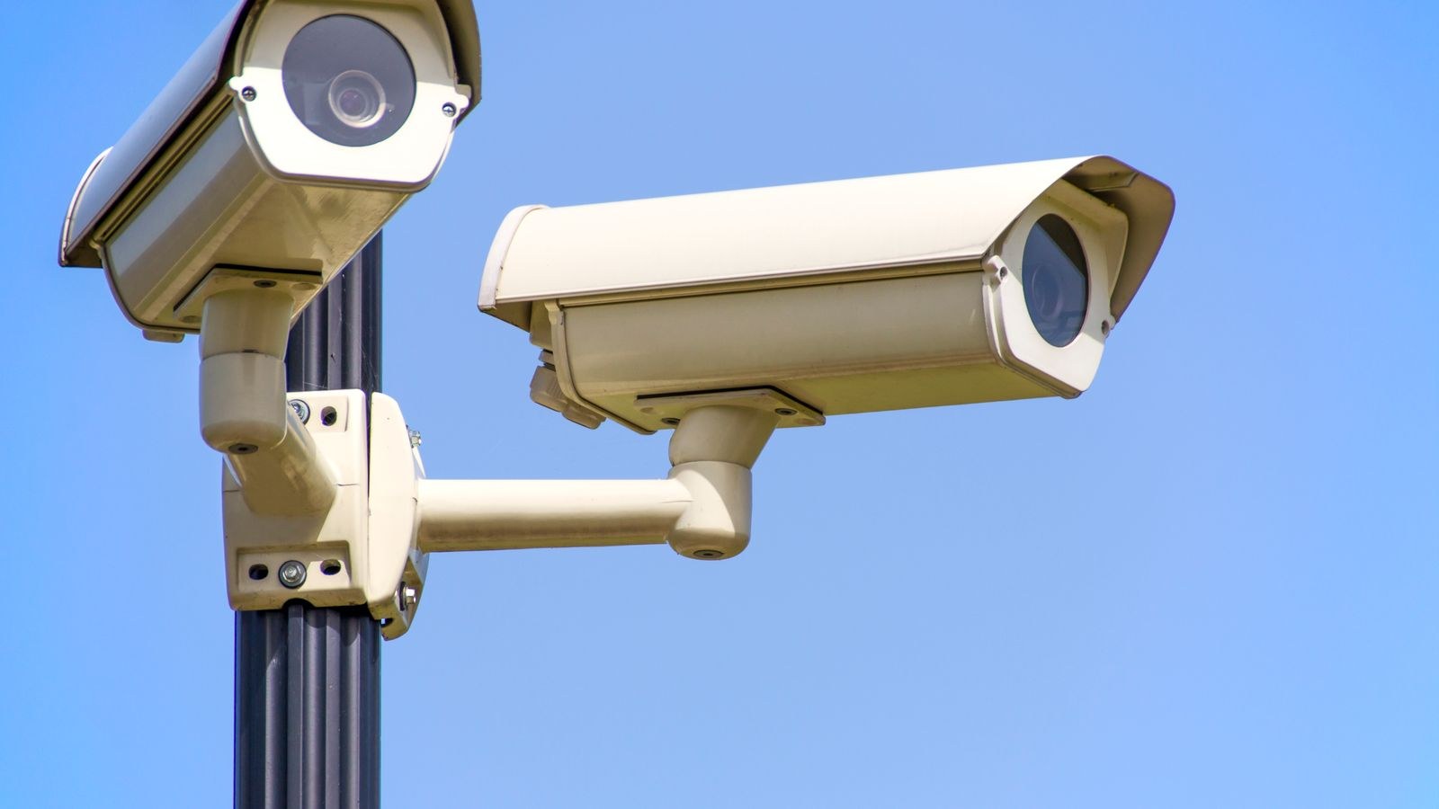 Outdoor cameras attached to a pole with band clamps instead of drilled fixings