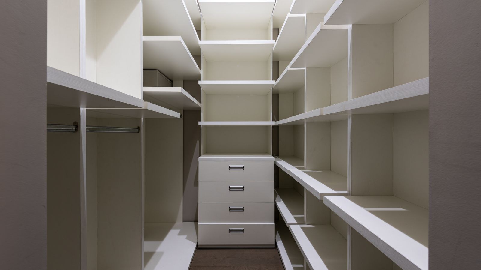 Tall closet shelving system with empty shelves for vertical apartment storage