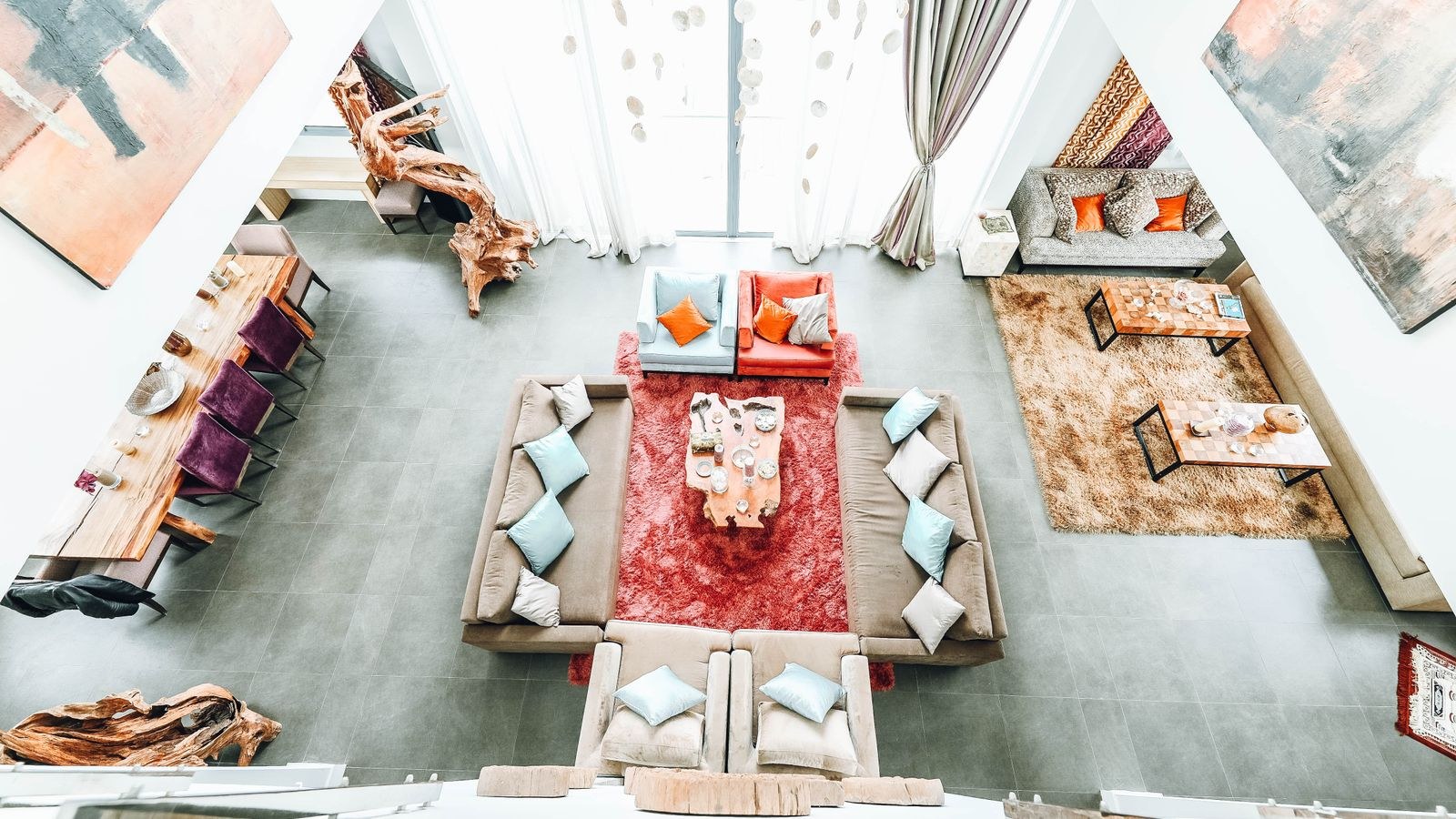 Living room seating arrangement with chairs angled toward a sofa and rug