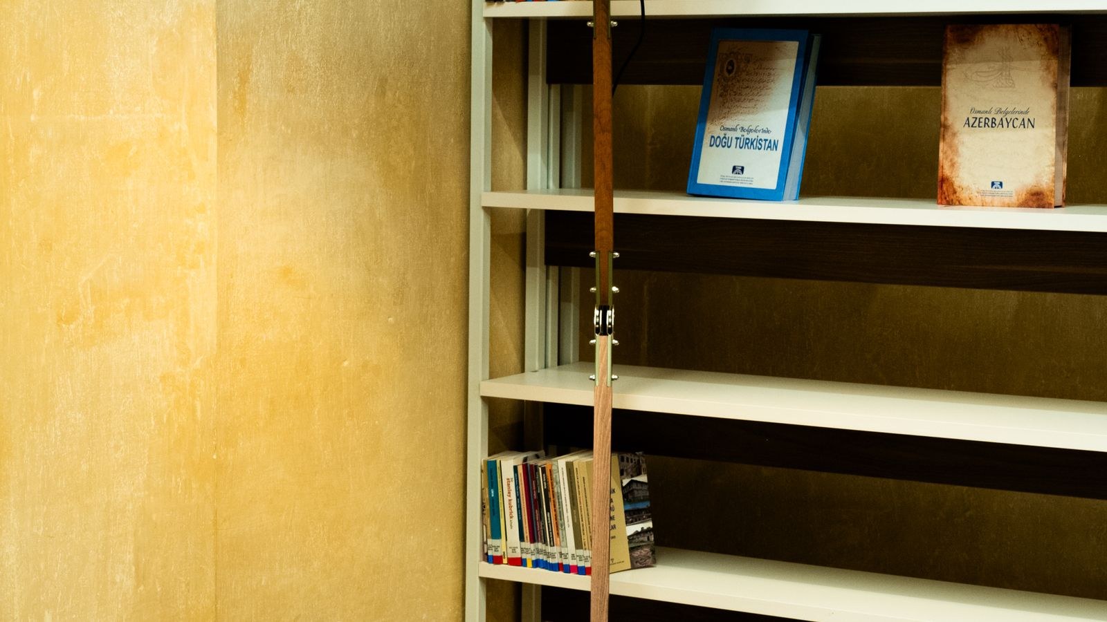 Cozy reading corner lit by a modern floor lamp next to an armchair