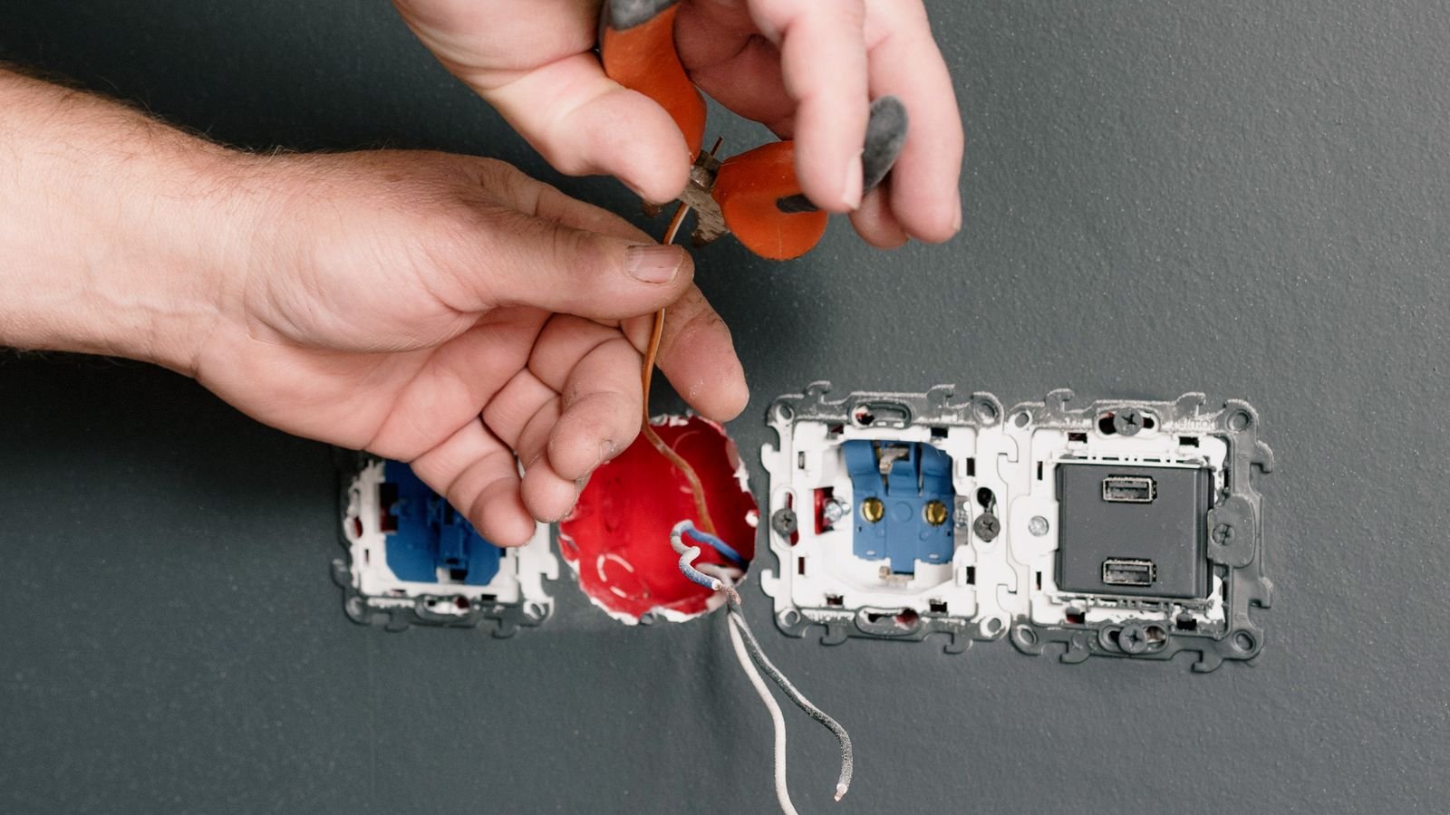 Electrician connecting low voltage wiring for a home doorbell transformer