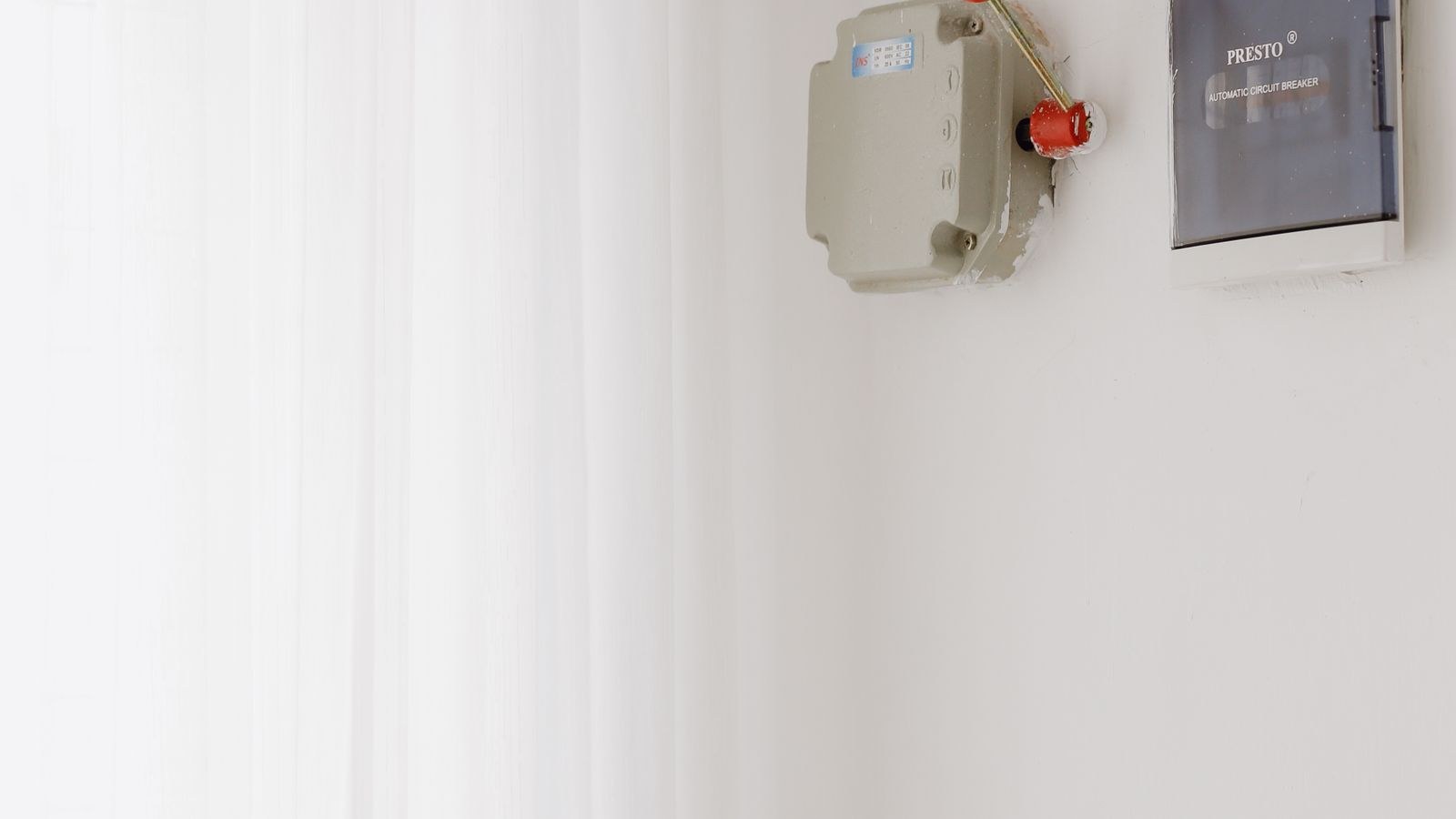 Home electrical circuit breaker panel mounted on a white wall