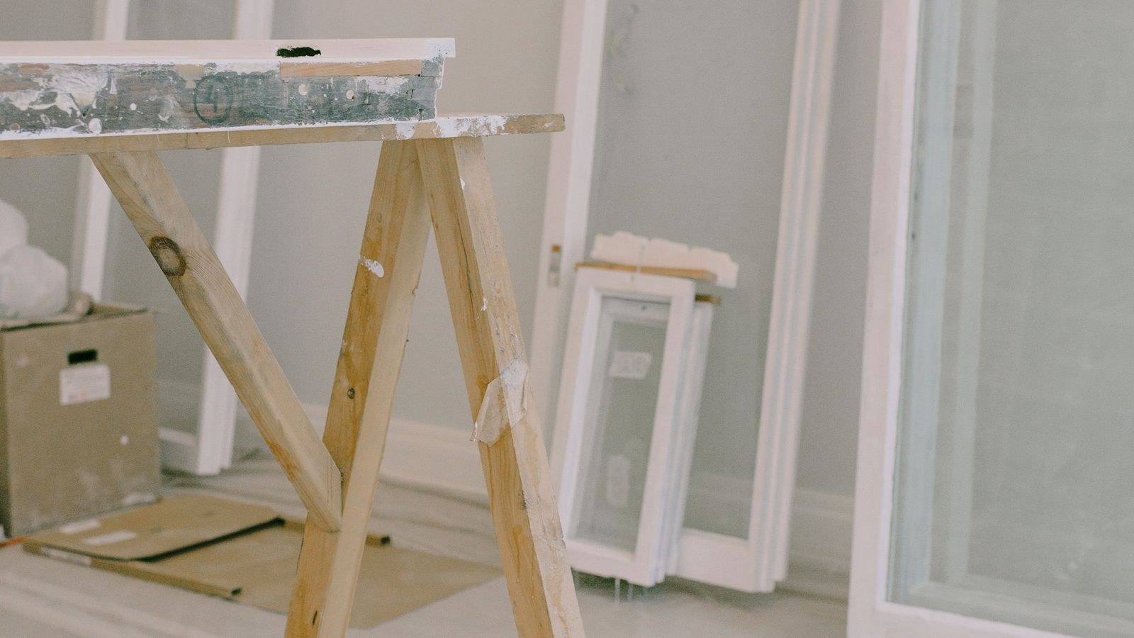 Window sash removed from its frame in a room being fitted with a portable AC vent panel