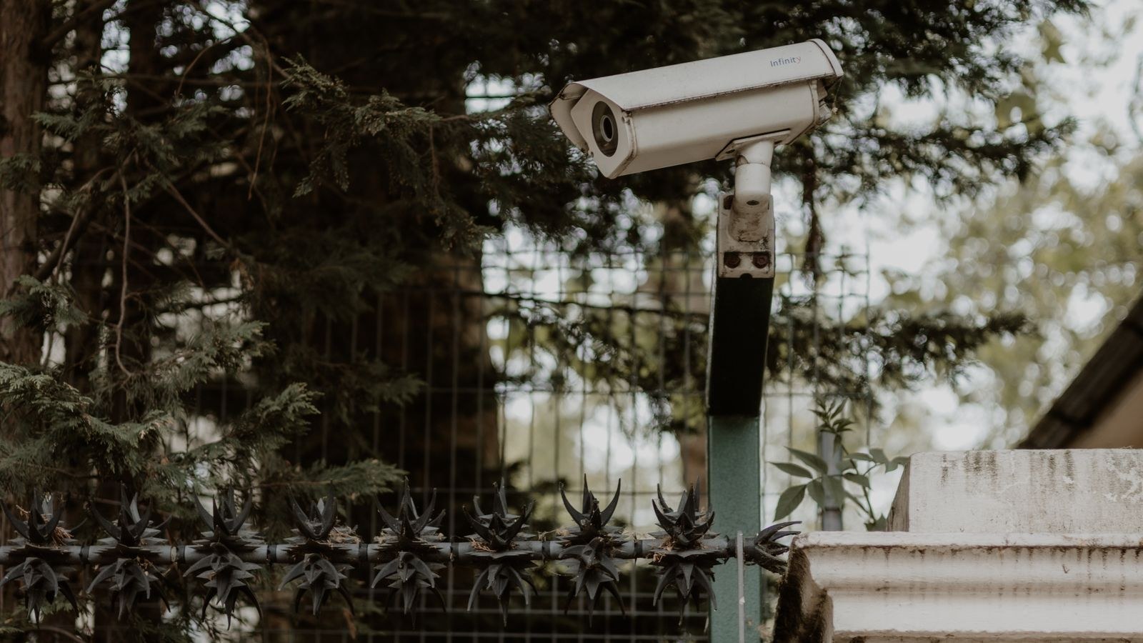 Outdoor security camera mounted on a wall watching a home entrance