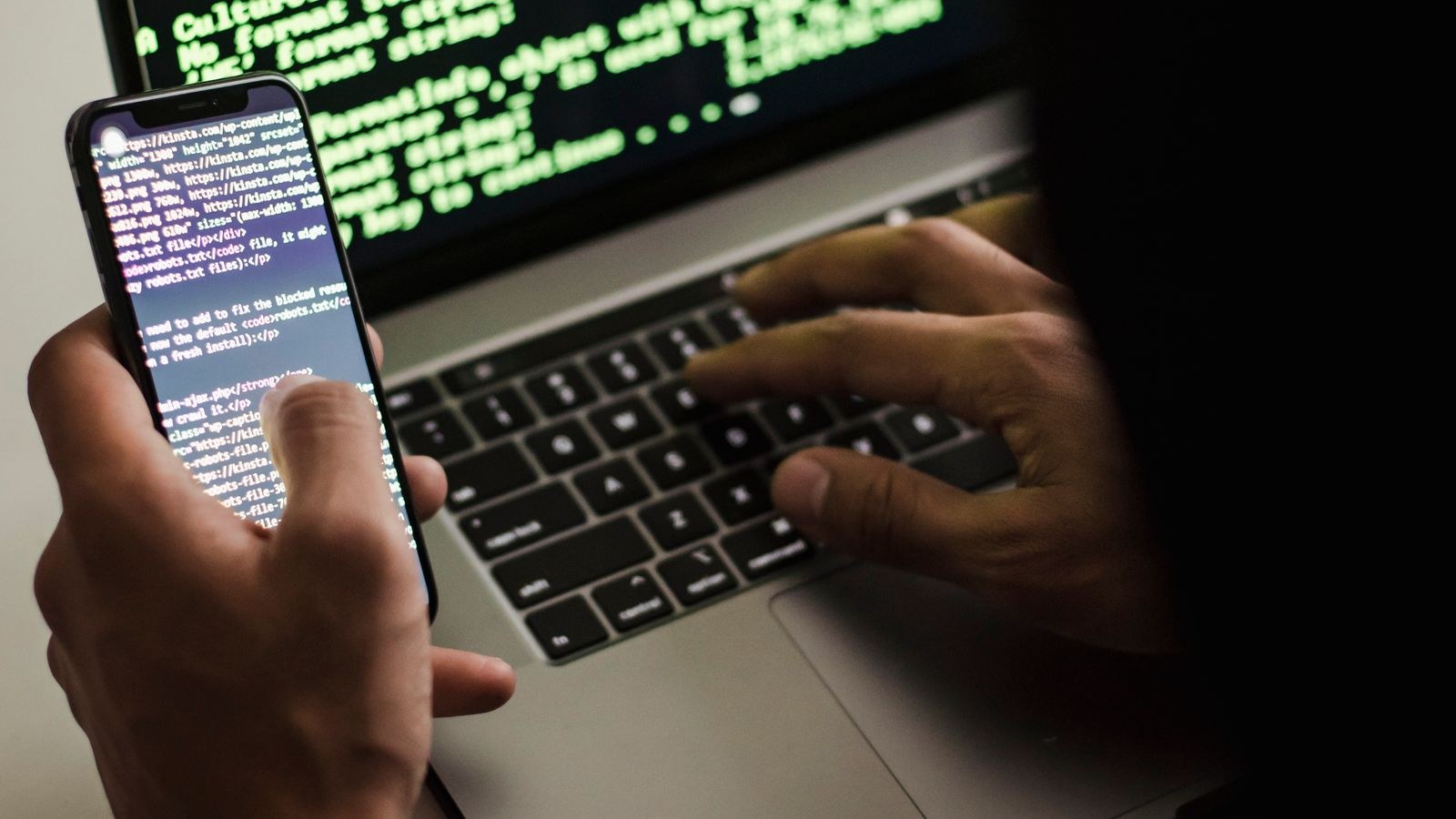 Laptop and phone showing account security and password settings for a smart camera system