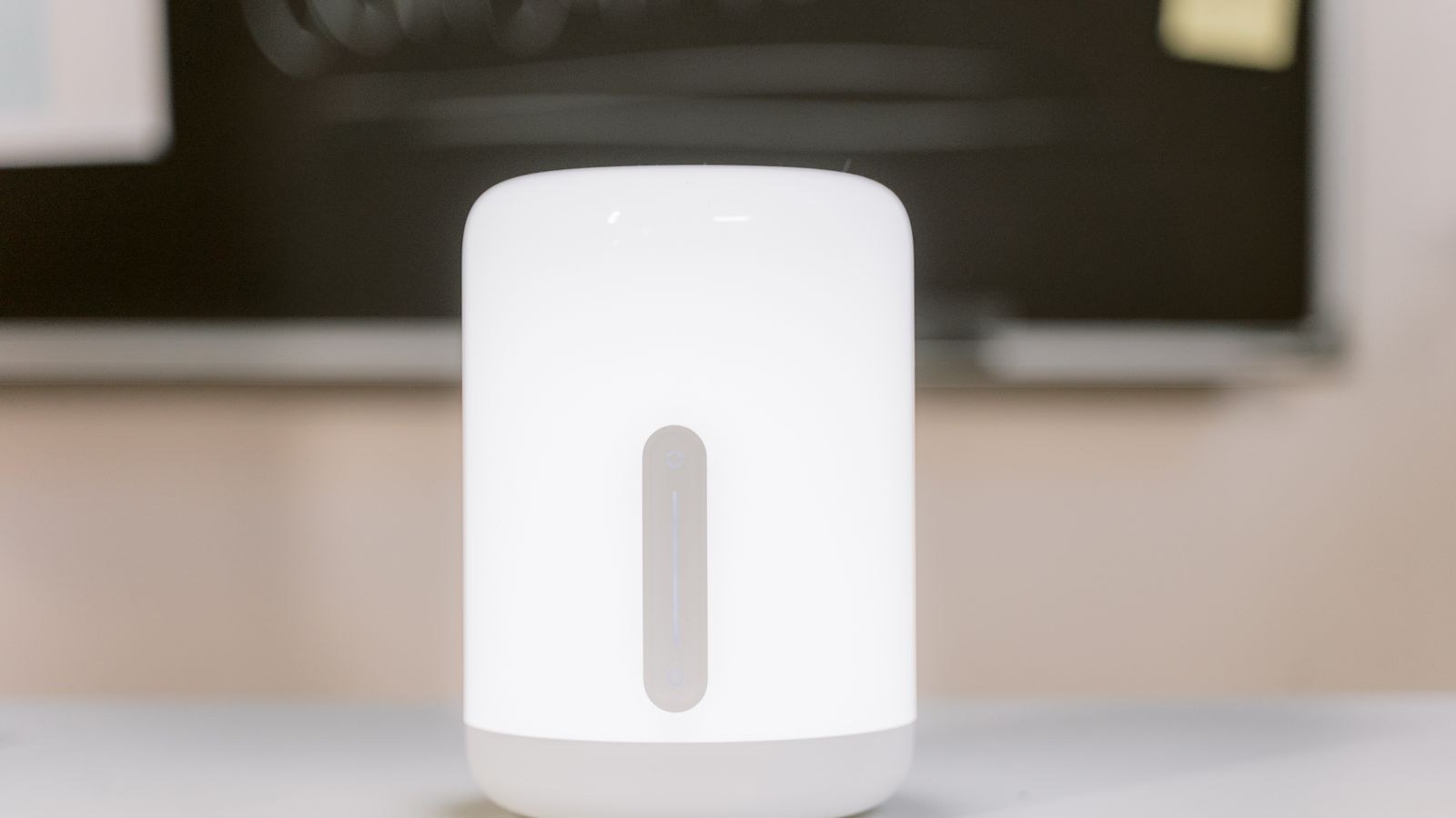 Modern white LED desk lamp providing task lighting during the day