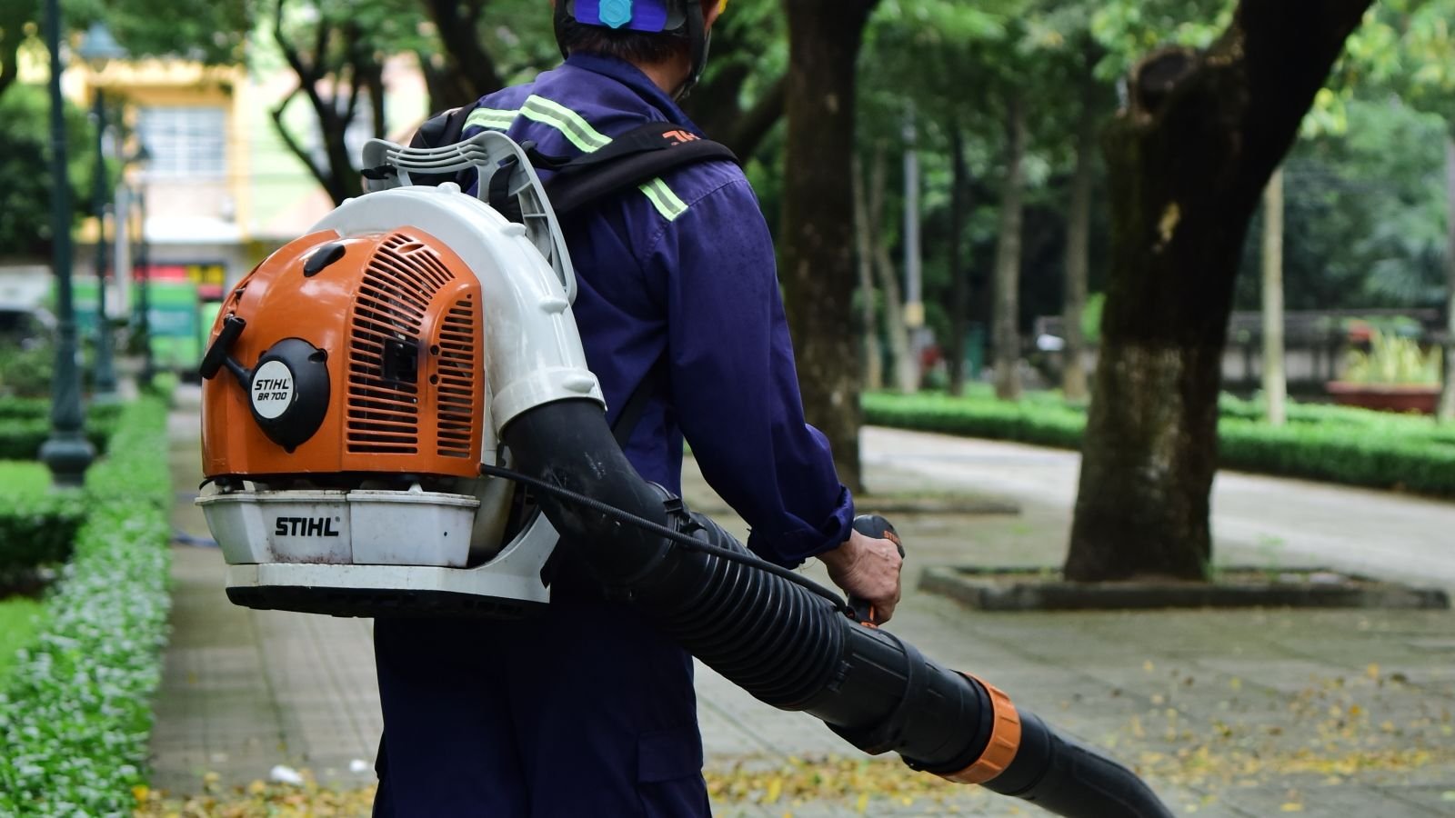 Leaf vacuum clearing fallen autumn leaves from a lawn during fall cleanup