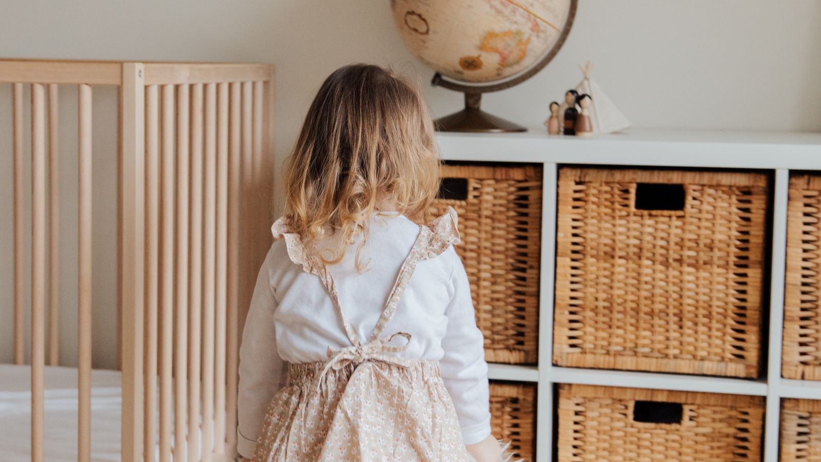 Baby nursery corner with rocking chair, side table and storage basket