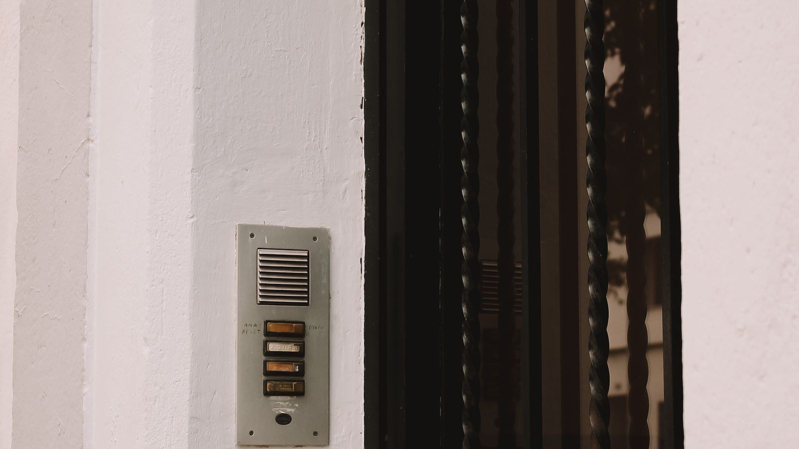 Building intercom panel on the exterior wall of a rental apartment block