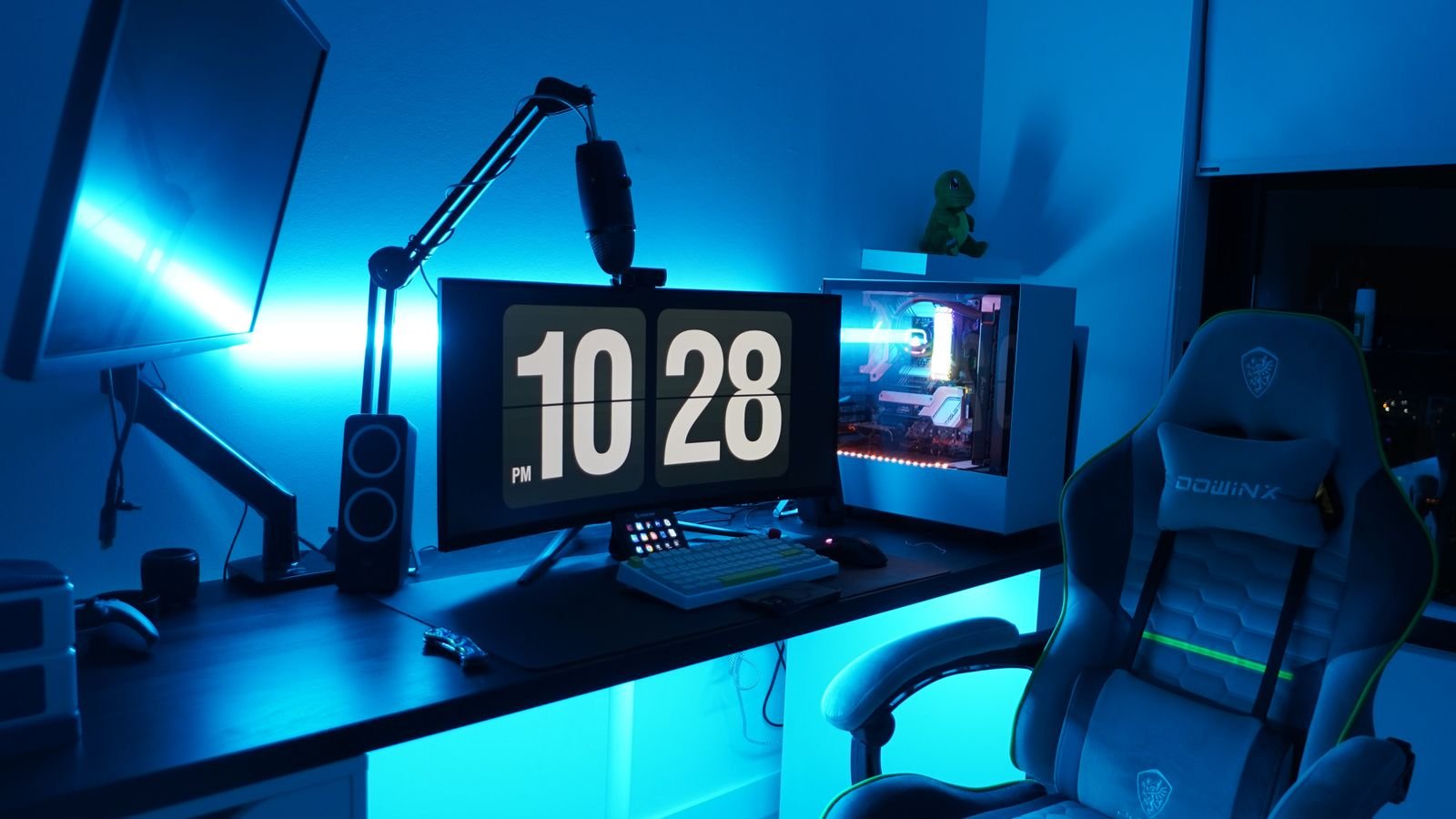 RGB LED strip lights glowing in colour along a wall in a modern room