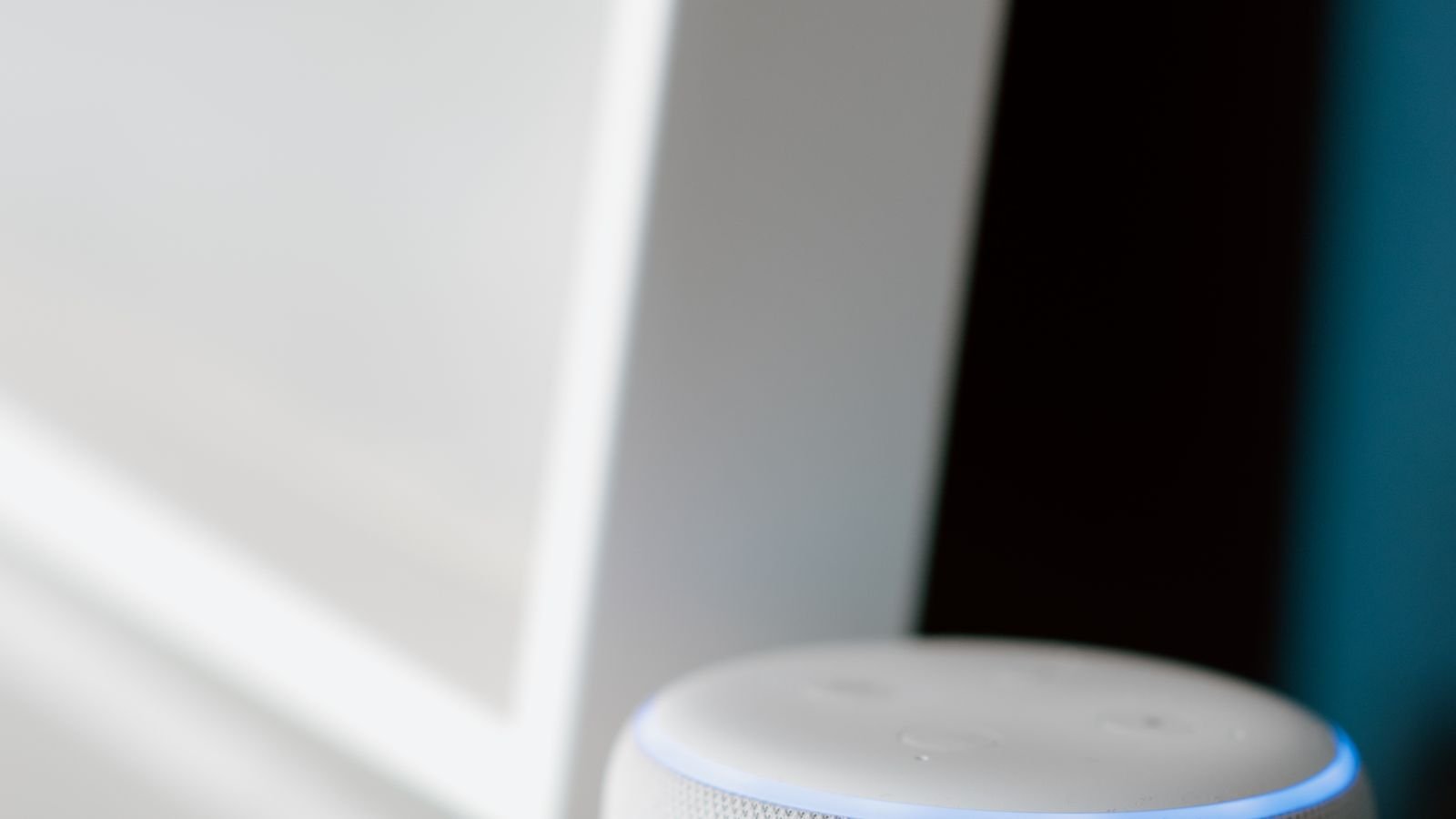 Smart speaker on a table used for voice control of smart home lighting