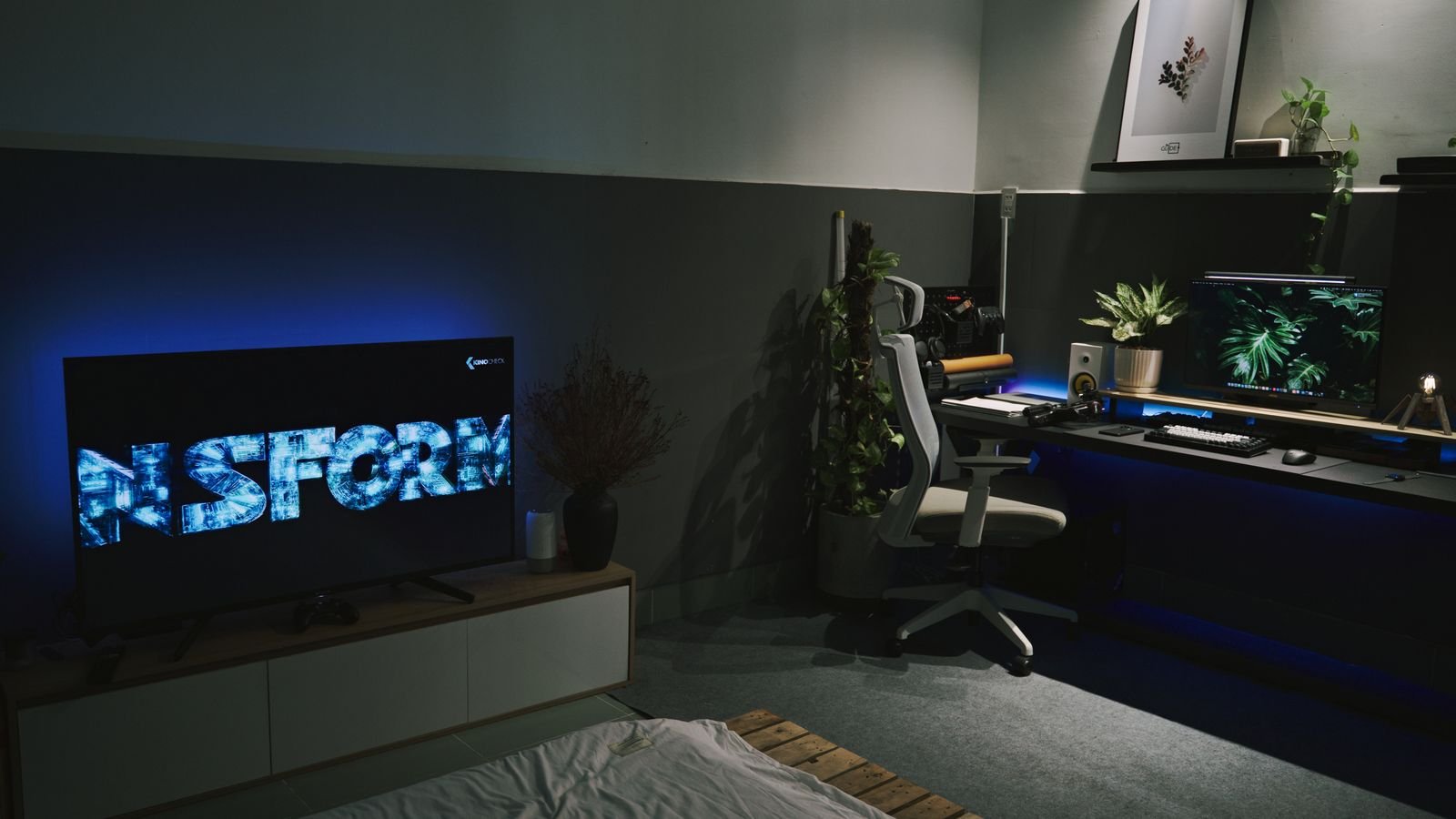 Flat screen TV with ambient LED backlighting in a modern bedroom setup