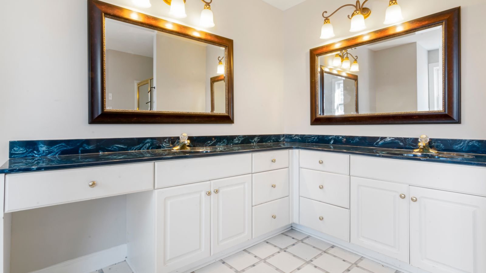 Bright bathroom vanity with mirror and wall-mounted light fixtures
