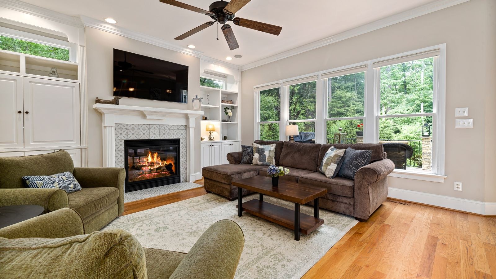 Living room area rug lying flat on a hardwood floor near seating