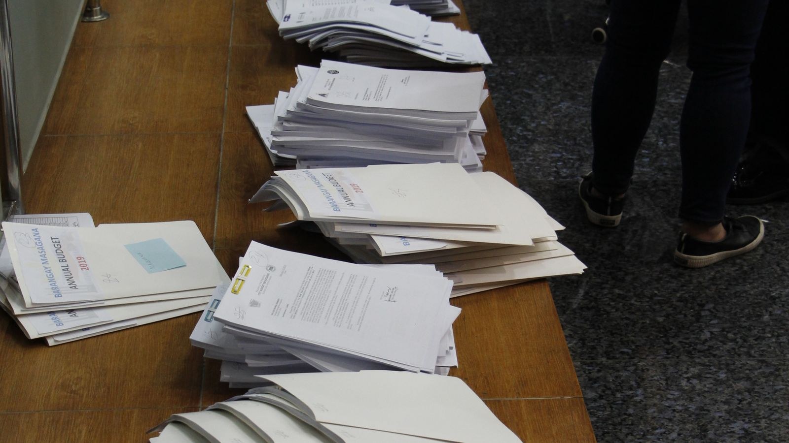Neatly arranged stacks of documents and folders organised on a desk