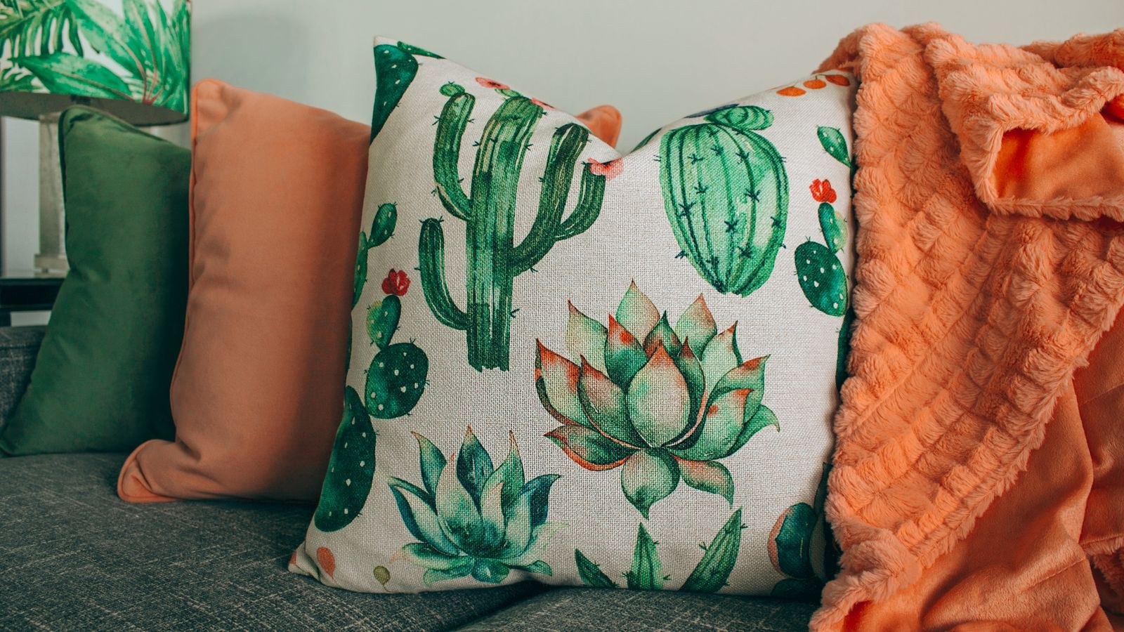 Throw pillows styled in odd numbers on a living room sofa