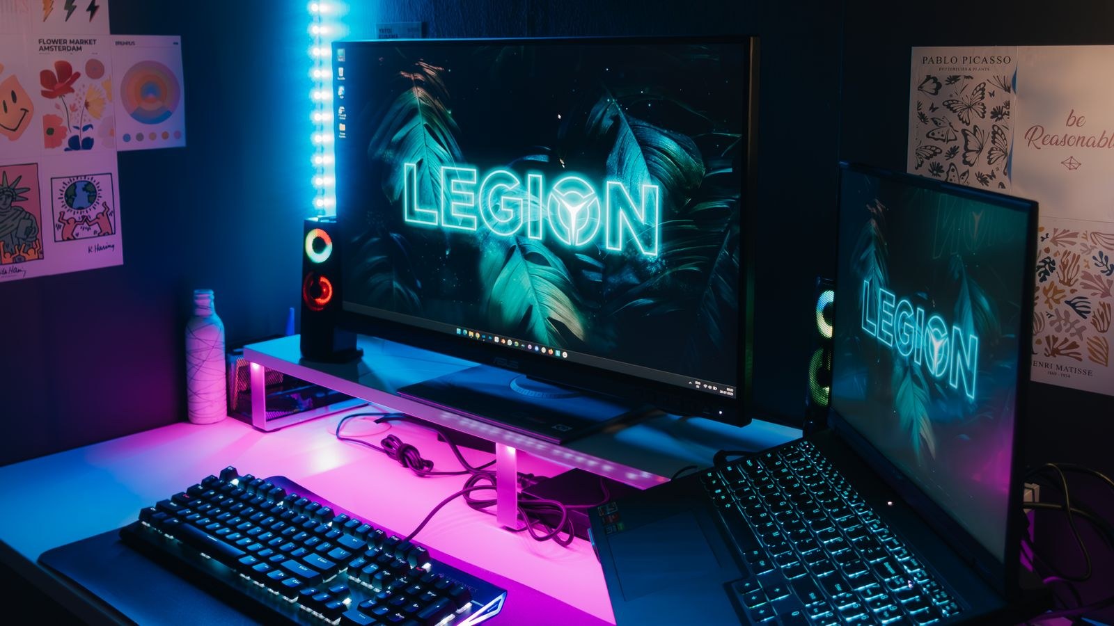 Gaming setup with neon LED lighting synced across dual monitors and desk
