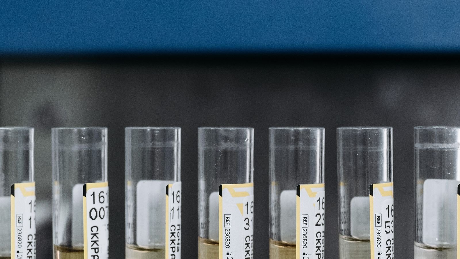 Glass of clear tap water beside a home water testing kit