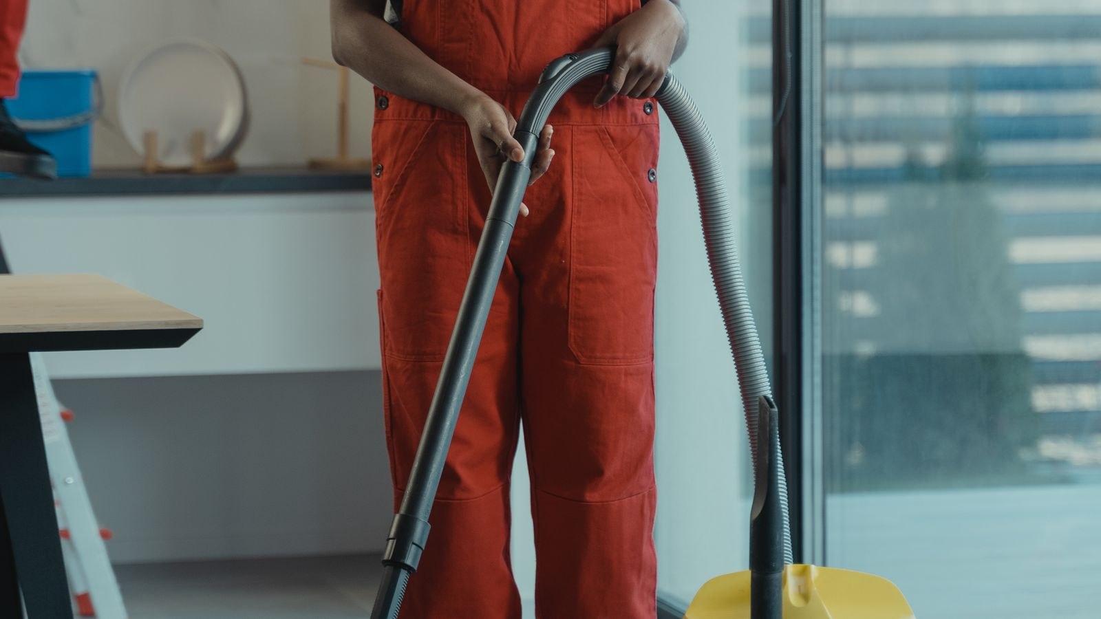 Vacuum cleaner hose detached from the machine for cleaning