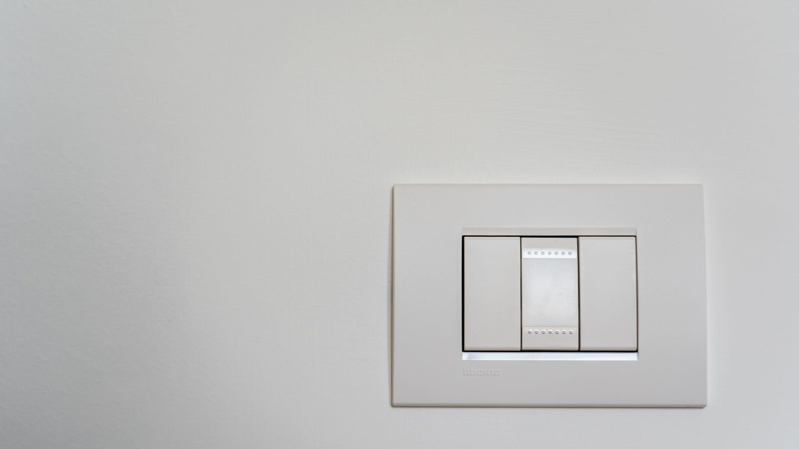 Modern white wall light switch ready for replacement with a timer switch