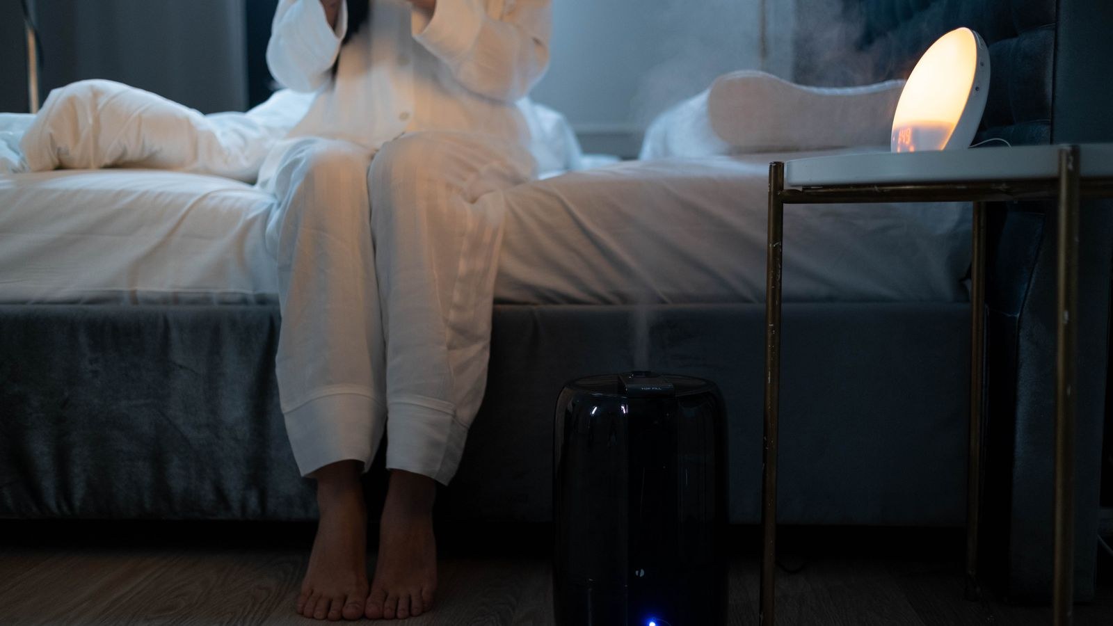 Humidifier mist filling a softly lit bedroom at night for better sleep