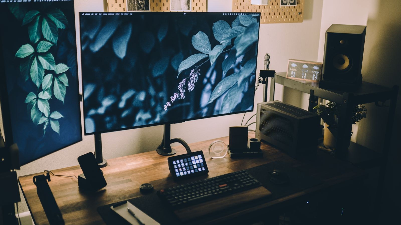 Adjustable monitor arm setup with keyboard and cable management on a wooden desk