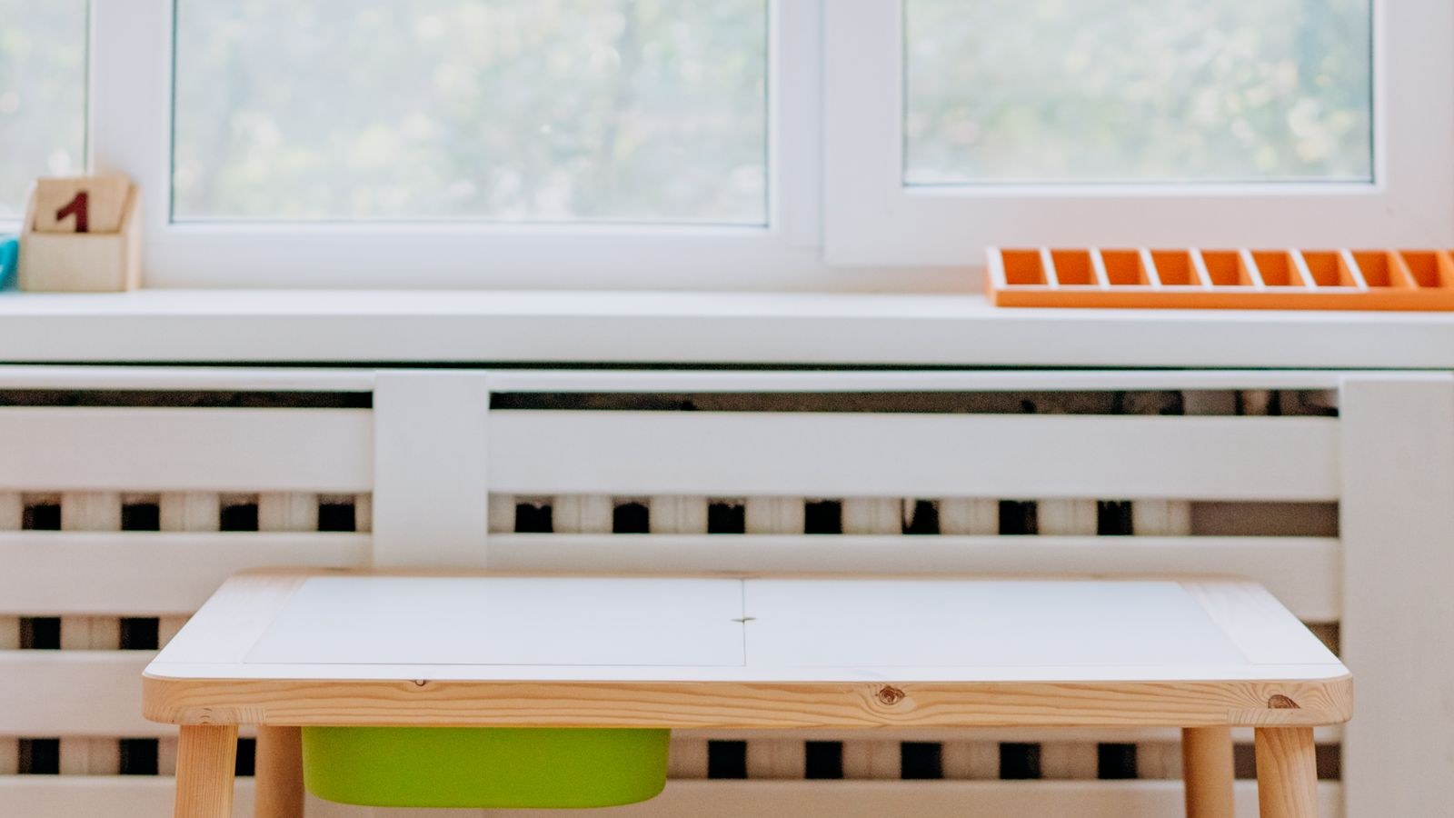 Kid friendly wooden table and stools in a bright sunlit playroom