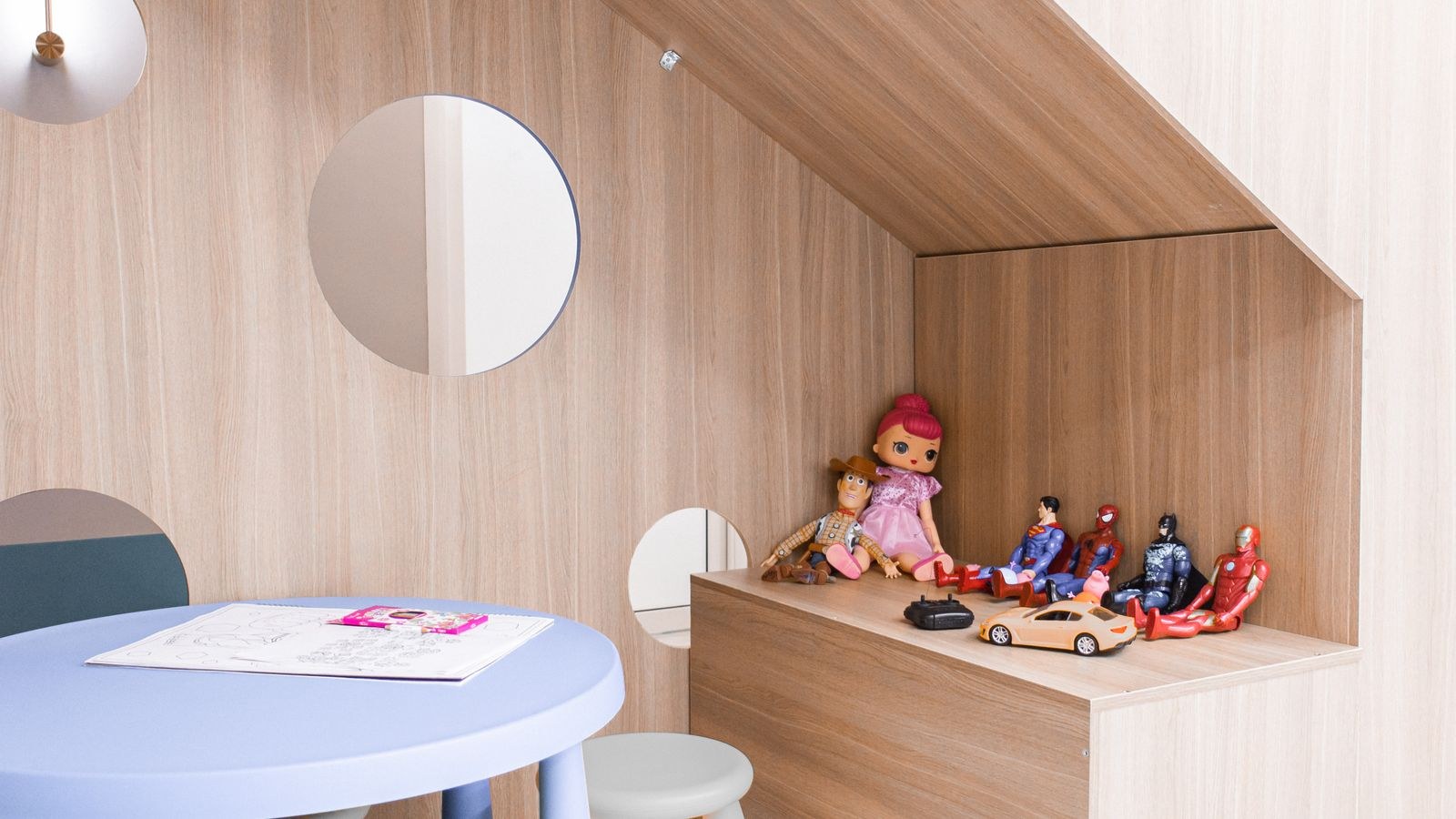 Child sized round table with stools and storage in a modern playroom