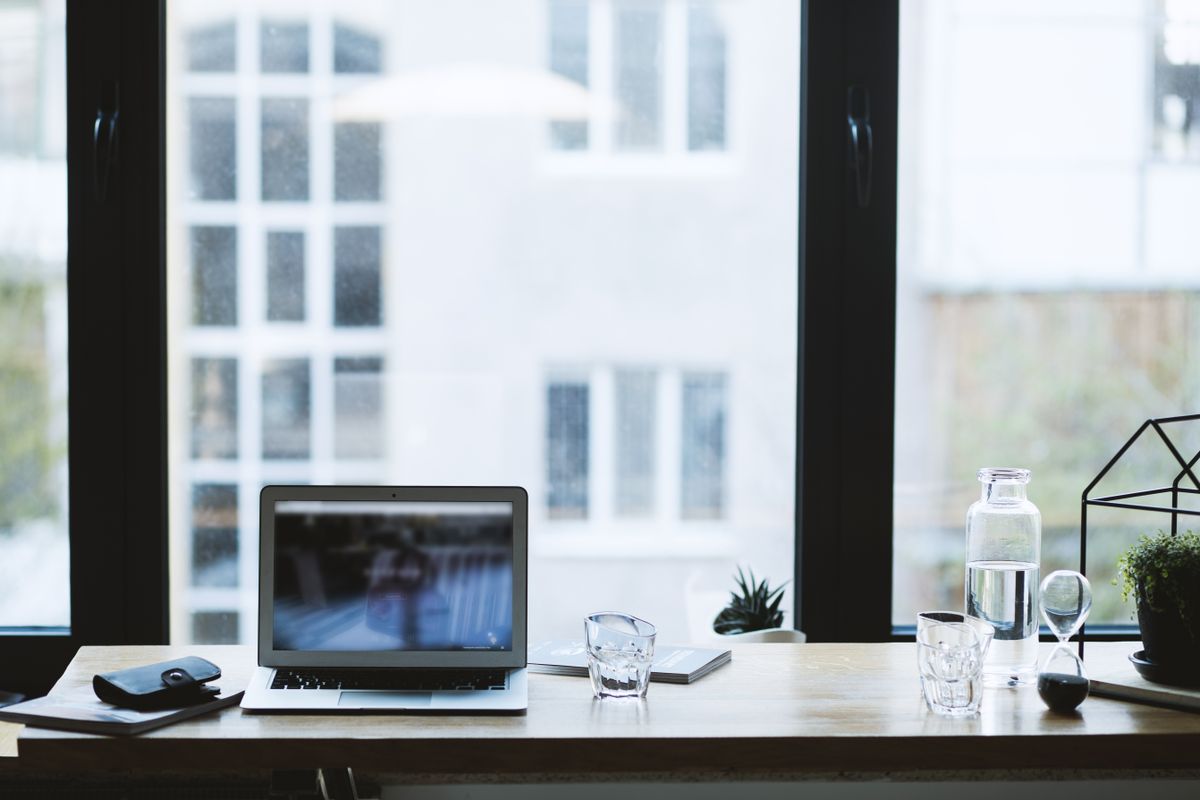 Straight desk against a wall in a compact home office